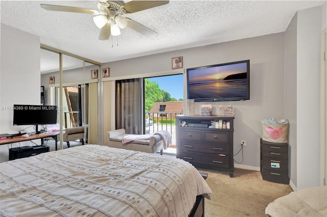 bedroom featuring access to exterior, ceiling fan, a textured ceiling, light carpet, and a closet