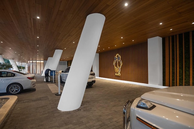 garage featuring wood walls and wooden ceiling