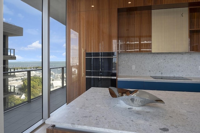 2655 S Bayshore Dr Unit 1212, Coconut Grove, FL 33133 - kitchen with backsplash, open shelves, a water view, modern cabinets, and light stone countertops