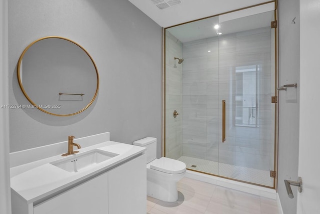 bathroom with tile patterned floors, vanity, toilet, and a shower with door