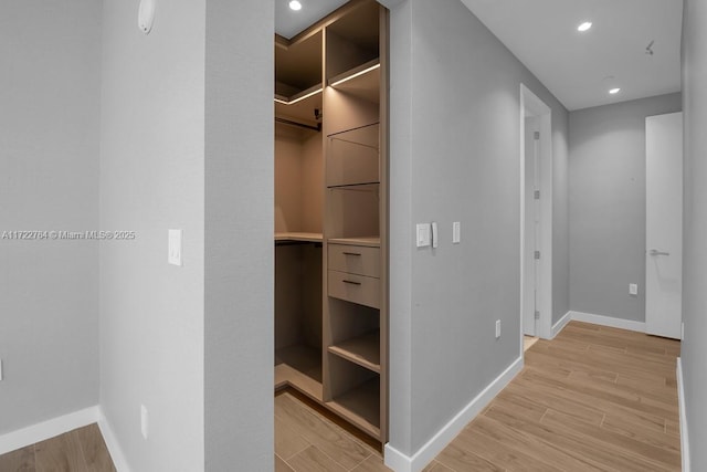 spacious closet featuring light hardwood / wood-style floors