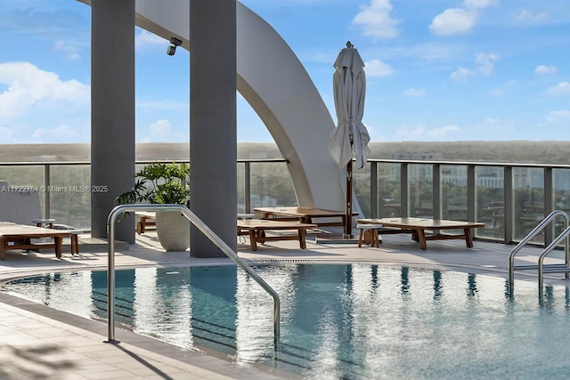 view of swimming pool featuring a patio area