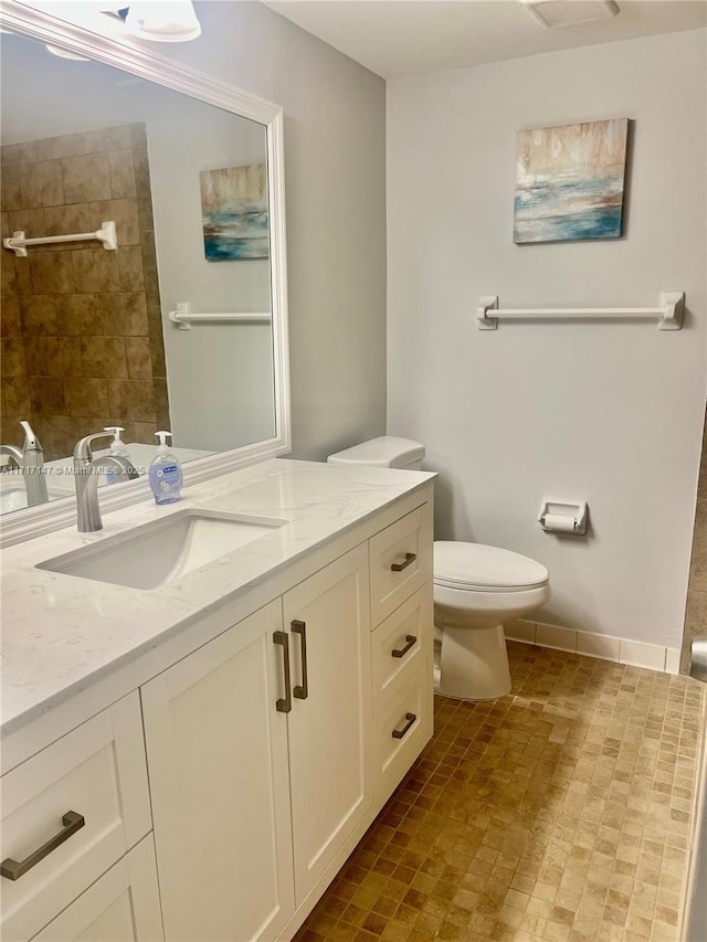 bathroom featuring vanity and toilet