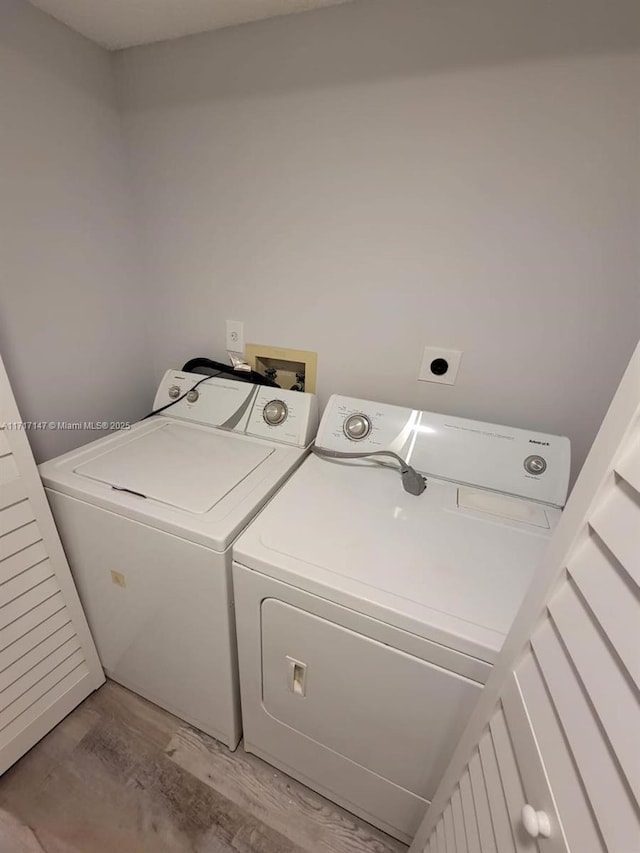 washroom featuring separate washer and dryer and light hardwood / wood-style floors