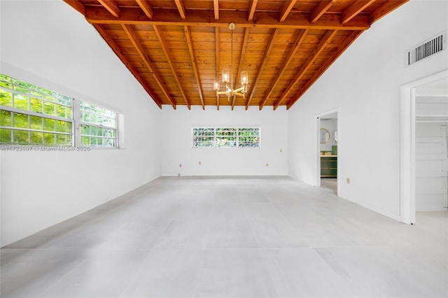 empty room with beamed ceiling, a notable chandelier, wood ceiling, and high vaulted ceiling