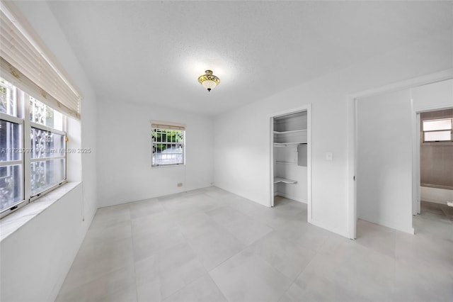 unfurnished bedroom featuring a textured ceiling