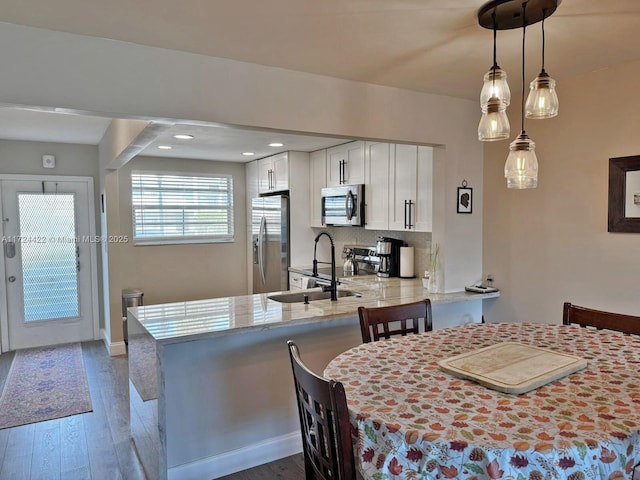 dining space featuring dark hardwood / wood-style flooring and sink