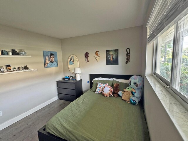 bedroom with dark wood-type flooring