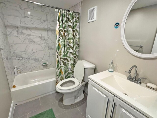 full bathroom with tile patterned flooring, vanity, toilet, and shower / bath combo with shower curtain