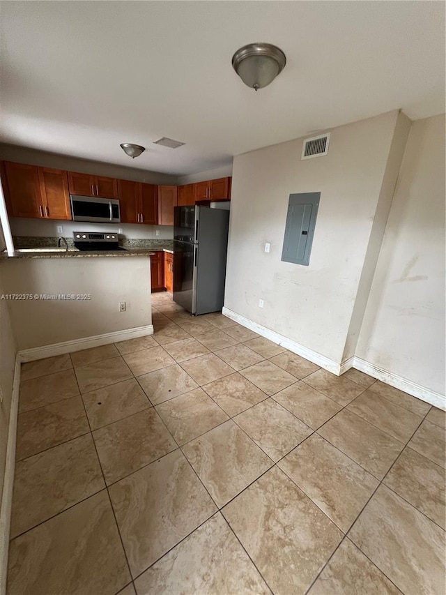 kitchen with light tile patterned floors, electric panel, kitchen peninsula, and appliances with stainless steel finishes