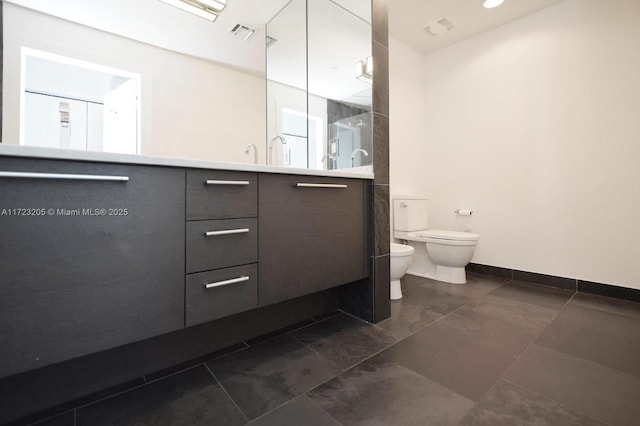 bathroom featuring tile patterned floors, vanity, a bidet, and toilet