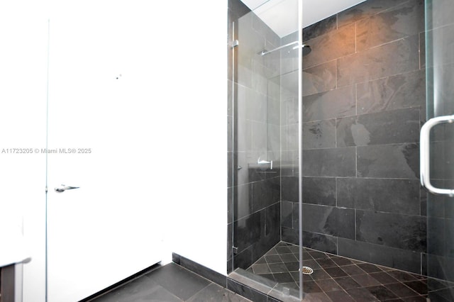 bathroom with tile patterned floors and a shower with shower door