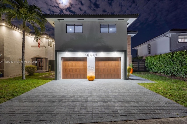 view of front of property with a front yard and a garage