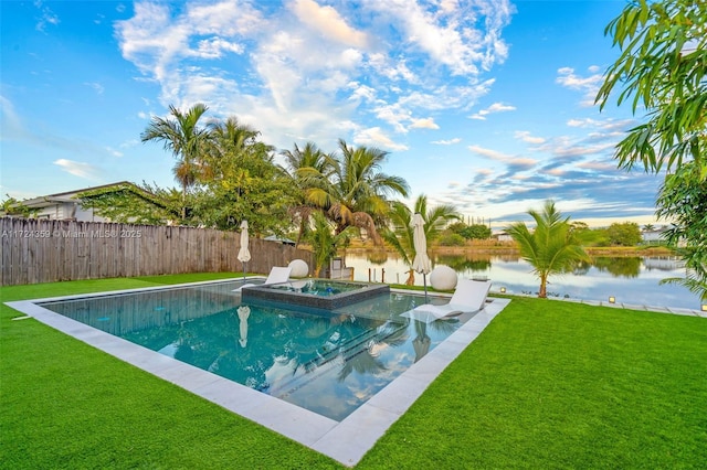 view of swimming pool featuring an in ground hot tub, a water view, and a lawn