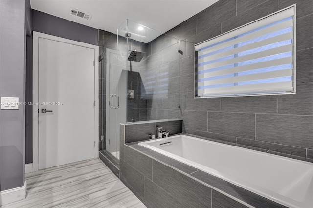 bathroom with separate shower and tub