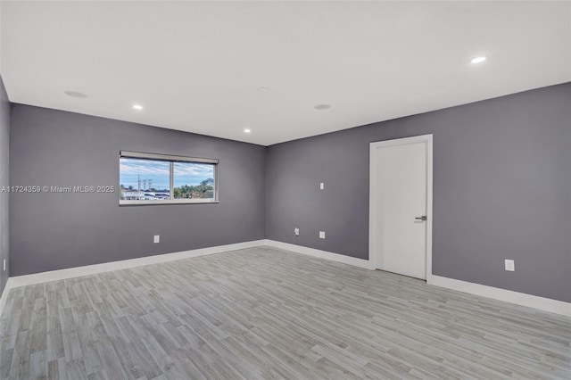 spare room featuring light hardwood / wood-style flooring