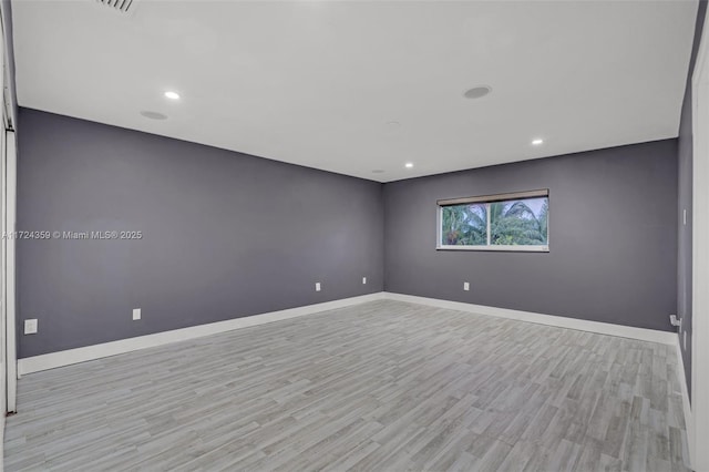 spare room with light hardwood / wood-style flooring