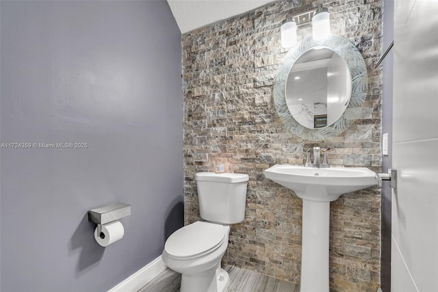 bathroom featuring hardwood / wood-style floors and toilet