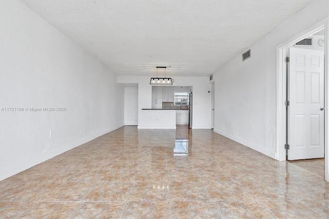 unfurnished living room featuring a textured ceiling