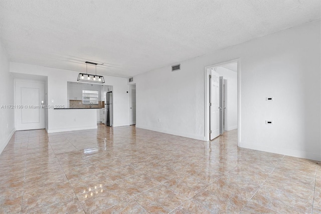 unfurnished living room with a textured ceiling