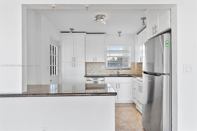 kitchen with stainless steel appliances, white cabinetry, and kitchen peninsula