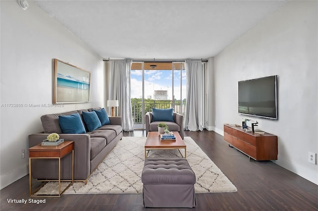 living room with hardwood / wood-style flooring and a wall of windows