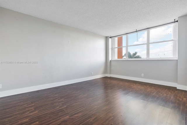 2450 NE 135th St Unit 406, North Miami, FL 33181 - spare room with dark wood-style flooring and a textured ceiling