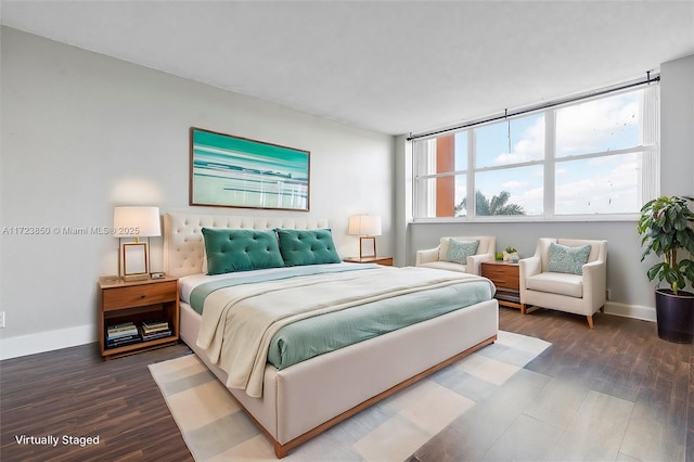 bedroom with dark hardwood / wood-style floors