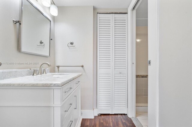2450 NE 135th St Unit 406, North Miami, FL 33181 - bathroom featuring a closet, vanity, and wood finished floors
