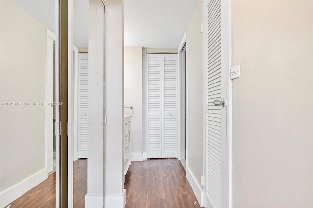 hallway with dark hardwood / wood-style flooring