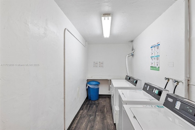 washroom with dark hardwood / wood-style flooring and separate washer and dryer