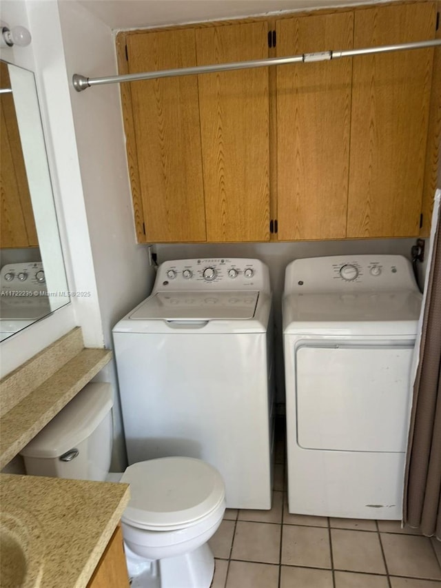 laundry area featuring separate washer and dryer and light tile patterned flooring