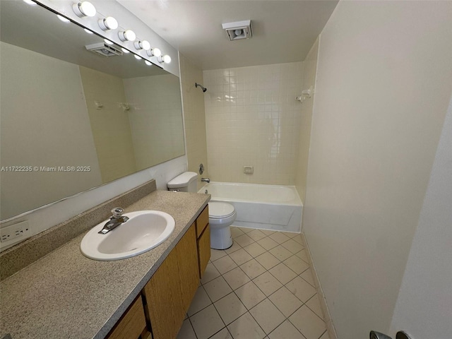 full bathroom featuring tile patterned flooring, vanity, toilet, and tiled shower / bath