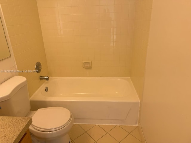 full bathroom featuring tile patterned flooring, vanity, toilet, and tiled shower / bath