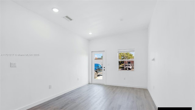 unfurnished room with light hardwood / wood-style flooring