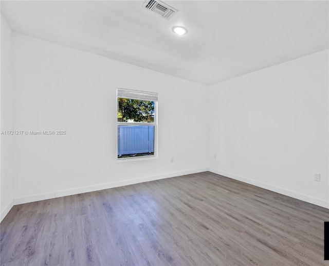 spare room with hardwood / wood-style flooring