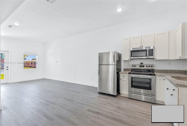 kitchen featuring white cabinets and stainless steel appliances