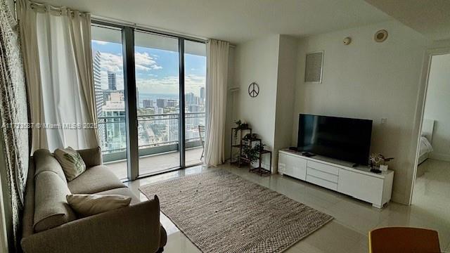 living room featuring floor to ceiling windows and light tile patterned floors