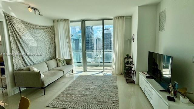 living area with floor to ceiling windows