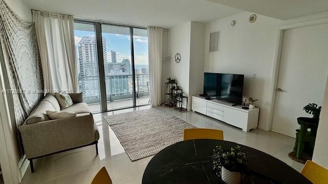 living room featuring a wall of windows