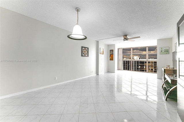 empty room with a textured ceiling and ceiling fan