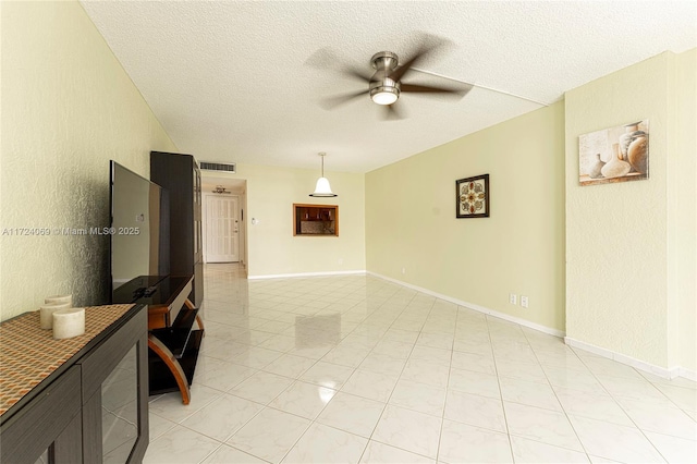 living room with ceiling fan and a textured ceiling