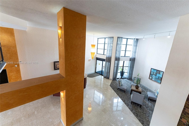 hall featuring a textured ceiling