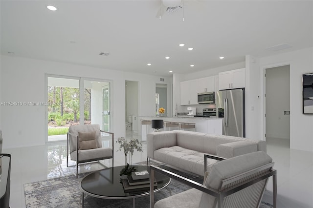 living room featuring light tile patterned floors and sink