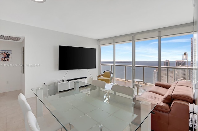 tiled living room with a wall of windows