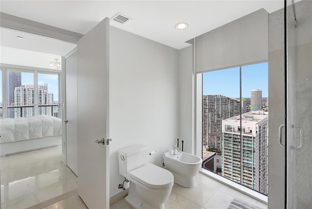 bathroom featuring tile patterned flooring, an enclosed shower, toilet, and a bidet