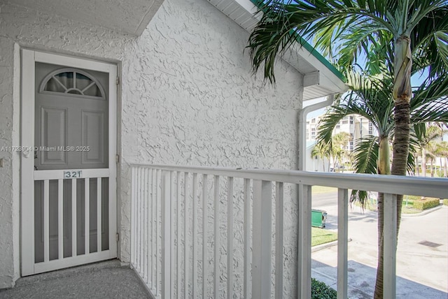 view of exterior entry featuring a balcony