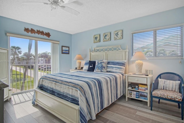 bedroom with a textured ceiling, access to outside, wood finished floors, and a ceiling fan