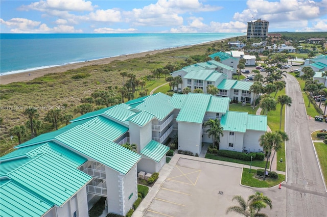 drone / aerial view with a water view and a view of the beach