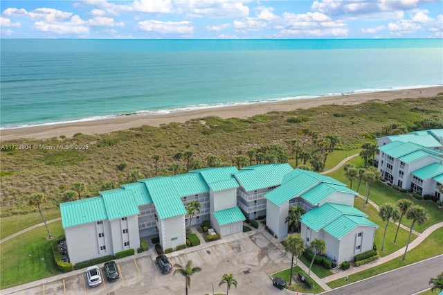 aerial view with a water view and a view of the beach